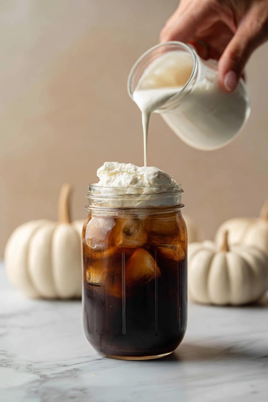 sweet cream cold foam - Flat lay of a small glass pitcher of whole milk with its creamy white texture, a dollop of thick heavy cream showing its rich and smooth surface, a small glass bowl filled with fine white powdered sugar, a tiny bottle of golden vanilla extract with a clear amber hue, and a few fresh vanilla bean pods with their dark glossy skin, all naturally arranged with soft shadows highlighting their fresh and creamy qualities, placed on white marbled surface, photo taken with an iphone --ar 2:3 --v 7